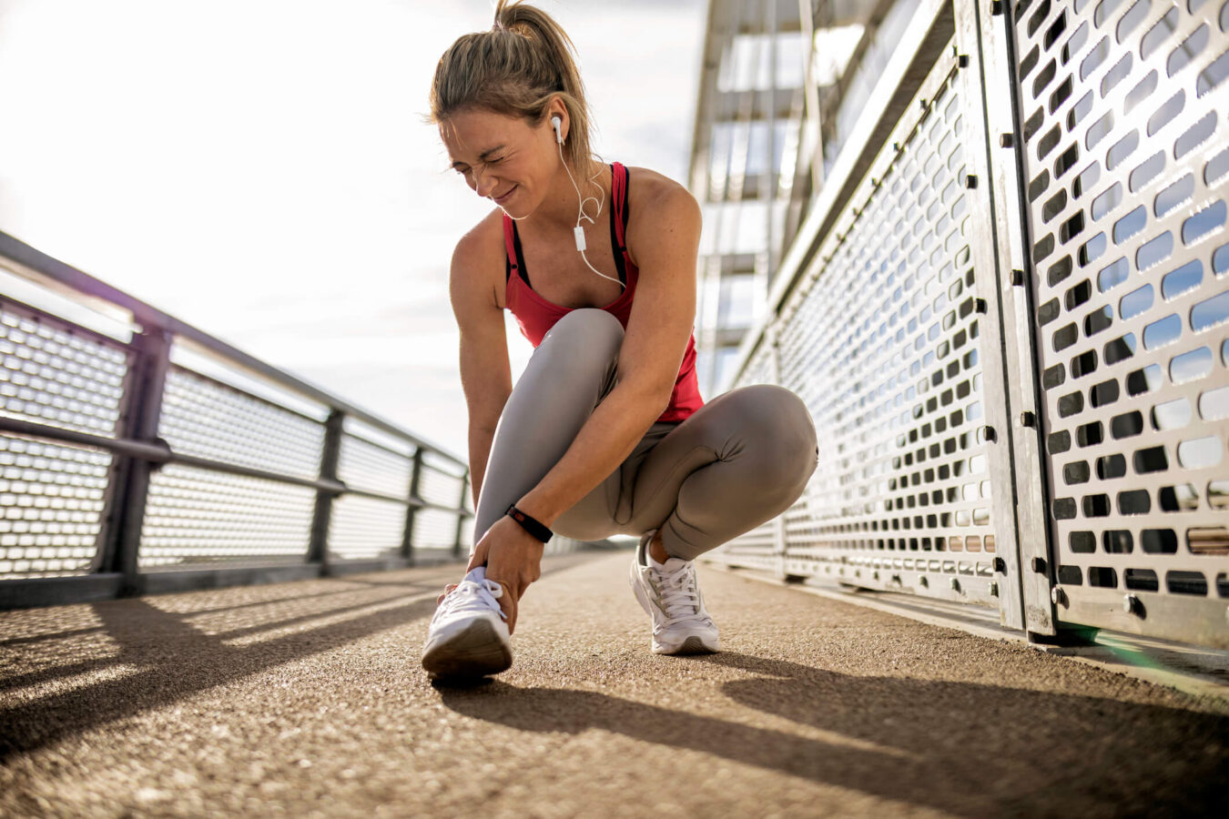 runner suffering from sprained ankle pain